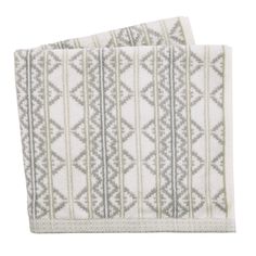 two white towels with grey and green designs