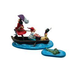 two figurines are riding in a boat with an alligator on the water next to them