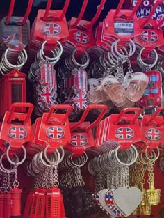 many different types of key chains and other items for sale in a market stall, with the british flag on them