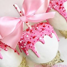 two decorated cupcakes with pink frosting and sprinkles