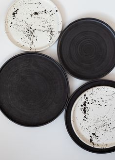 three black and white plates sitting next to each other