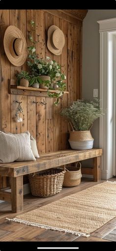 a wooden bench sitting next to a wall with hats on it