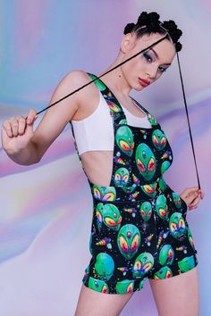 "Short overalls for summer printed all over with green alien heads all over. That is the vibe this summer! Let's travel to the stars in these cheeky green alien shortalls and conquer new words. These short dungarees are all about the rave party that might last eternally. ► Material & Washing It's soft, warm, and stretchy. It consists of 80% Polyester, 20% Elastane & feels like Cotton ► Colors The fabric dyes are remarkably vivid, so I must warn you that you will stand out in the crowd! There is Galaxy Creature, Alien Aesthetic Outfit, Summer Streetwear Women, Alien Clothing, Alien Outfit, Short Dungarees, Alien Clothes, Womens Overalls, Rave Style