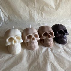 three candles that have been placed in the shape of skulls