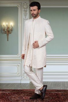 Upgrade your ethnic wardrobe with our Mens Sherwani- S2-S377. This regal garment features stunning open jacket thread embroidery with intricate white beads, stones, and cutdana. Experience the perfect blend of traditional and modern style, elevating your look for any special occasion. Mens Sherwani, White Beads, Modern Style, Special Occasion, Wardrobe, White