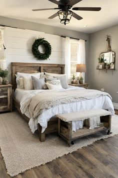 a bedroom with a bed, dressers and ceiling fan in the middle of it