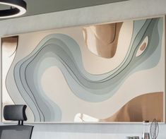 an office with a large painting on the wall