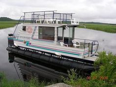 a house boat is docked on the water