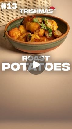 a bowl filled with potatoes sitting on top of a table next to a wicker basket