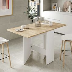 a kitchen table with two stools next to it