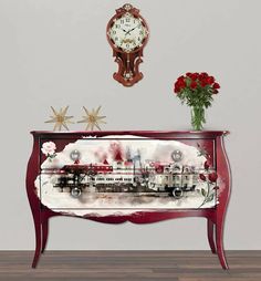 a red dresser with a clock and flowers on top