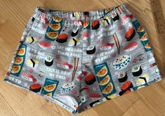 Sushi on gray background flannel sleep shorts Size small 100% cotton flannel  Enclosed elastic waistband with 1/2" non-roll elastic Low rise Side seams 2" inseam on all sizes Hip sizing:   XS(32-34"), S(35-37"), M(38-40"), L(41-43") Front rise:  XS(9 3/4"), S(10 1/2"), M(11 1/2"), L(12 3/4") Back rise:  XS(13 1/2"), S(14 1/2"), M(16"), L(16 3/4") Measurements are approximate  Sizing allows for about 2-3 inches of ease/shorts run a size smaller than the pants All seams are sewn with a serger except for topstitching on waistband and hems. Fabric is not prewashed.  Shrinkage is vertical. Best to wash in cold water separately or with like colors.  Do not soak garment.  Remove promptly into dryer on low heat.  No chlorine bleach. Note:  shorts run small Flannel sleep shorts are not returnable F Relaxed Fit Shorts With Elastic Waistband For Bedtime, Relaxed Fit Bedtime Shorts With Elastic Waistband, Relaxed Fit Elastic Waistband Shorts For Bedtime, Cotton Pajama Shorts For Loungewear In Gray, Gray Cotton Pajama Shorts For Loungewear, Casual Pajama Shorts With Elastic Waistband For Bedtime, Gray Pajama Shorts For Loungewear, Gray Pajama Shorts For Summer Loungewear, Flannel Shorts