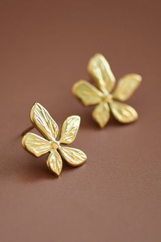 Approx. 0.7" x 0.7" These are hypoallergenic, waterproof, fade-resistant, and tarnish-free, ensuring their beauty lasts for years. Perfect for everyday wear or special occasions. Flower Stud Earrings | Simple Gold Earrings | Waterproof & Sweatproof Jewelry | Simple Lightweight Earrings | Minimalist Earrings | Real Gold Dipped Earrings | Real Gold Plated Earrings | Stainless Steel Metal Earrings Gold Flower Shaped Jewelry For Summer, Gold Flower-shaped Jewelry For Summer, Rose Gold Flower-shaped Jewelry For Summer, Hypoallergenic Flower-shaped Earrings For Anniversary, Hypoallergenic Flower-shaped Metal Jewelry, Summer Hypoallergenic Jewelry With Flower Shape, Hypoallergenic Flower-shaped Summer Jewelry, Summer Hypoallergenic Jewelry In Flower Shape, Summer Hypoallergenic Flower-shaped Jewelry