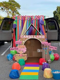 there is a candy land decorated with balloons and streamers in the back of a truck