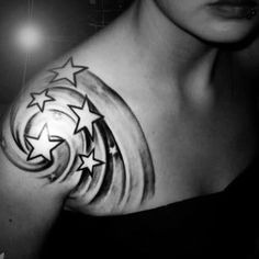 a woman's arm with stars and crescent tattoo on her left shoulder, in black and white