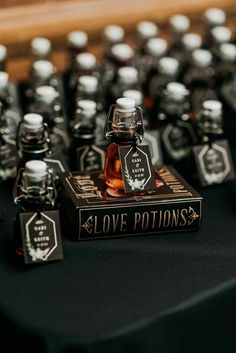 bottles of love potions sitting on top of a table