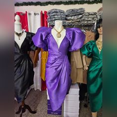 mannequins dressed in purple and green dresses