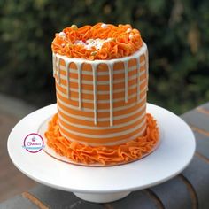 an orange and white striped cake with icing