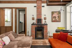 a living room filled with furniture and a fire place