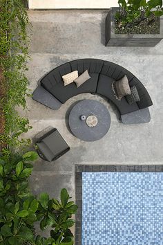 an overhead view of a living room with couches and tables next to a swimming pool