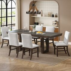 a dining room table with white chairs around it