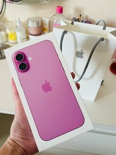 a person holding up an iphone case in front of a counter with other items on it