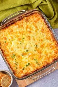 a casserole dish with cheese and crackers