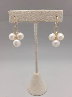 Three freshwater pearls dangle from gold filled chain. Simple, sophisticated and easily dressed up or down all year long. Lightweight and perfect for bridesmaids or graduation gifts.  All pieces will be packaged together in a cotton filled jewelry box unless otherwise specified. Please let us know if your order is a gi Classic 14k Gold Filled Pearl Drop Jewelry, Graceful Dangle Jewelry With Pearl Drop, Graceful Dangle Pearl Drop Jewelry, Graceful Pearl Drop Dangle Jewelry, Elegant 14k Gold Filled Pearl Drop Jewelry, Adjustable 14k Gold-filled Jewelry With Pearl Drop, Adjustable 14k Gold-filled Pearl Drop Jewelry, Wire Wrapped Pearl Dangle Jewelry, Handmade 14k Gold Filled Pearl White Jewelry