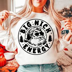 a woman wearing a white shirt with the words,'big nick energy'printed on it