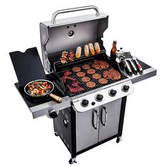 an outdoor grill with food cooking on the top and side burners, including hamburgers