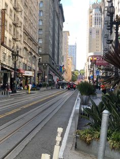 an empty city street in the middle of a big city