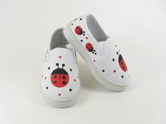 PLEASE SEE MEASUREMENTS BELOW. Our little ladybug shoes are too cute! We have hand painted sweet ladybugs on the toes and all around the sides and backs of our slip on sneakers. They are white canvas with rubber soles and elastic at the sides to help with fit. Comfy! Great for ladybug theme birthday parties or Halloween costumes. Measurements: Taken on the inside length of the shoes: Size 5/6 Toddler: 5 and 1/4 inches long Size 7/8 Toddler: 5 and 3/4 inches long Size 9/10 Toddler: 6 and 1/4 inch Donut Shoes, Custom Baby Shoes, White Canvas Sneakers, Painting Shoes, Baby Vans, Baby Shoes Diy, Ladybug Theme, Girls Shoes Sneakers, Hand Painted Shoes