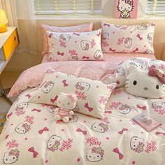 a hello kitty bed set with pink polka dots and bows on the comforter is shown