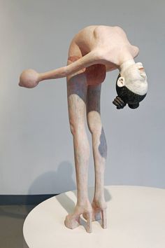 a sculpture of a person doing a handstand