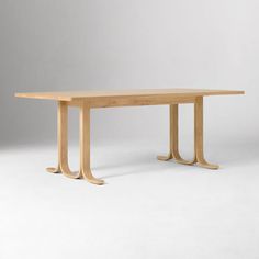 a long wooden table with two legs on the top and one leg extended to the side