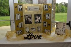 a table with some pictures on it next to a sign that says love and is decorated with yellow ribbon