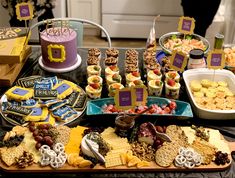 a table filled with lots of different types of snacks and desserts on top of it