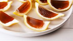 sliced oranges are arranged on a white plate