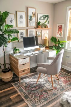 a home office with plants and pictures on the wall