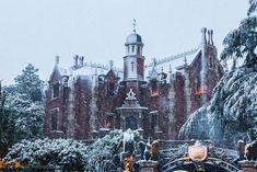 a large building covered in snow next to trees