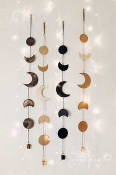 a wall hanging with different types of moon and crescents on it's sides