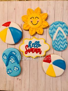 decorated cookies with the words relax and beach written on them are displayed in front of a wooden background