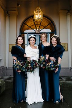 the bride and her three bridesmaids pose for a photo