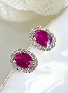 "Natural Ruby (1.10ct) Diamond Halo Solid 14k Yellow Gold Stud Earrings, New* These beautiful earrings are made of solid 14k yellow gold and features 2pcs, genuine, natural, oval, ruby gemstones measuring 4 mmx 5.75mm (1.10ct). These earrings have a classic design with a 24pc diamond halo of single-cut gemstones (I, VS2, 0.10ctw). These earrings are studs with pushbacks for closures, they measure 0.33\"x 0.22\" and weigh 1.95 grams. The gemstones are natural and have inclusions, the color satura Luxury Oval Ruby Earrings, Oval Red Diamond Earrings For Anniversary, Red Oval Diamond Earrings For Anniversary, Aaa Quality Oval Diamond Earrings, Hallmarked Oval Diamond Earrings, Oval Ruby Earrings For Anniversary, Oval Ruby Earrings With Halo Design, Red Oval Halo Design Earrings, Classic Oval Diamond Earrings Aaa Quality