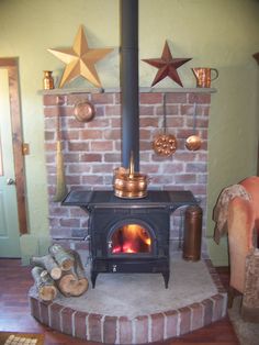 a fire place in a living room next to a chair and star decorations on the wall