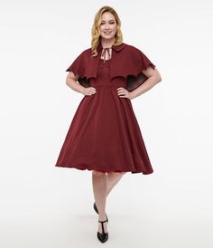 Fresh from Unique Vintage, in collaboration with Disney, this swing dress is crafted in a burgundy lightweight woven fabric. The sweetheart bodice is secured with flexible side boning while the waistband is cinched with a back zipper. The gathered swing skirt is outfitted with side pockets while a chilling capelet, in a bat wing silhouette and grey plaid inside, covers your shoulders! Wing Silhouette, Bat Wing, Grey Plaid, Bat Wings, Swing Dress, Woven Fabric, Bat