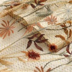 the fabric has been embroidered with flowers and leaves on it's side, along with sequins