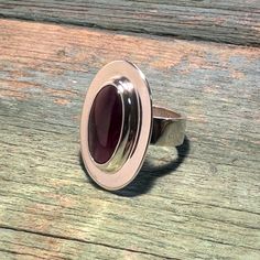 Here is a stunning, eye catching sterling silver ring.  It features a lovely, large, natural rhodolite garnet long oval cabochon, bezel set, with a wide policshed frame around it. This stone is around 10ct. It is deep pink with a great luster. It is transparent and lightly included. The setting is open back. The shank is a simple wide, flat, robust sterling silver band. It is a beautiful piece of jewelry. This ring's size is 6.5 Thank you for looking! . Modern Silver Ruby Ring With Oval Shape, Sterling Silver Ruby Ring Oval Cabochon For Formal Events, Sterling Silver Ruby Ring, Oval Cabochon For Formal Events, Formal Sterling Silver Ruby Ring With Oval Cabochon, Oval Cabochon Ruby Ring In Sterling Silver, Sterling Silver Ruby Ring With Polished Finish, Oval Sterling Silver Ruby Ring Stamped 925, Silver Oval Ruby Ring With Large Stone, Oval Cabochon Ruby Ring In Silver