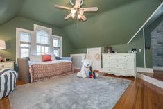 there is a stuffed animal on the floor in this child's room with green walls