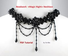 a black beaded necklace with beads and tassels attached to the neckline